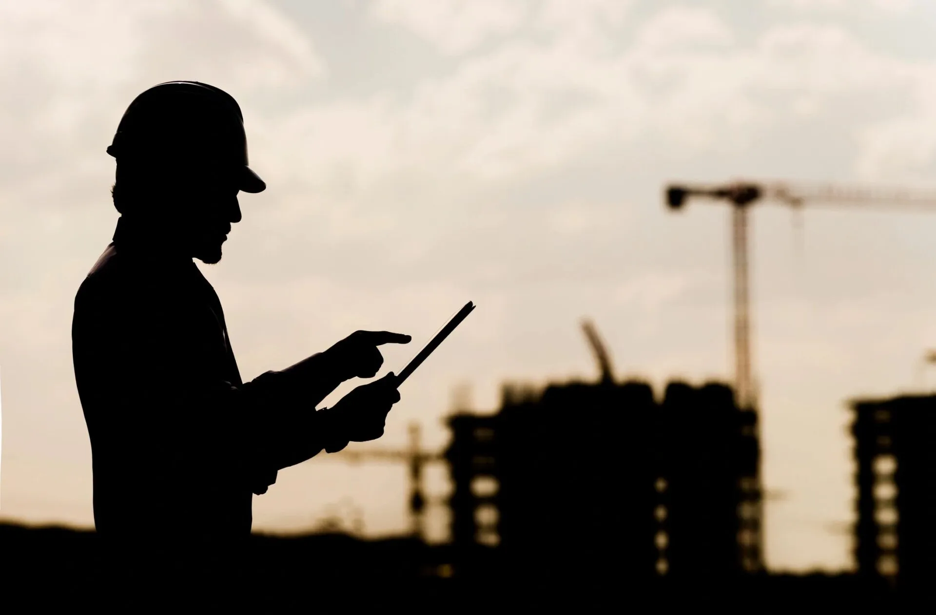 Site engineer reviewing plans at a construction site