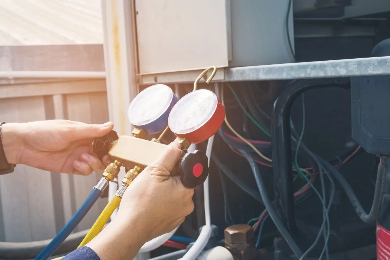 HVAC technician servicing an aircon unit
